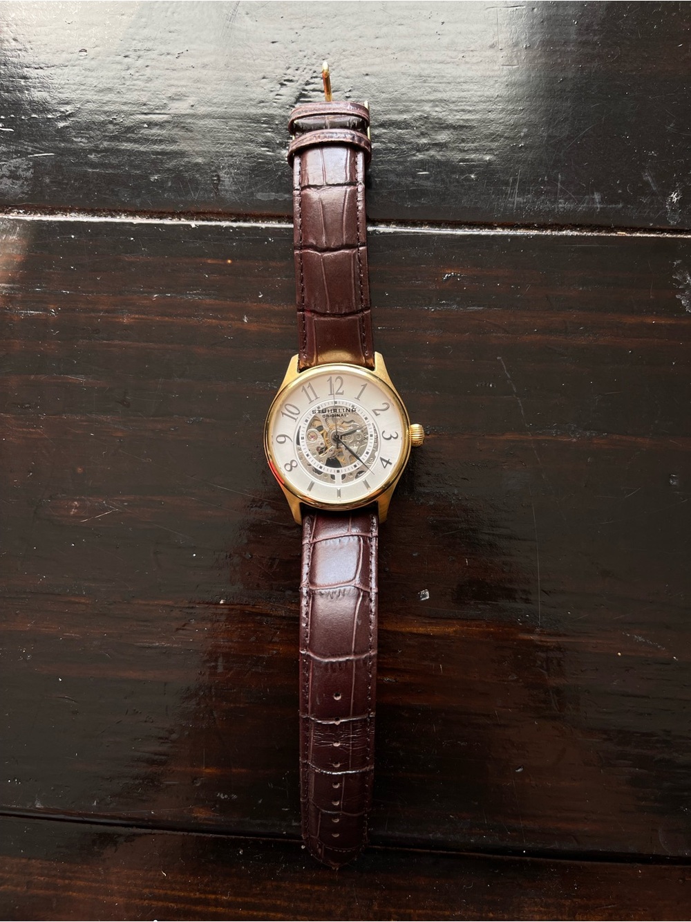 gold-tone Stührling Original Delphi Solaris automatic skeleton wristwatch